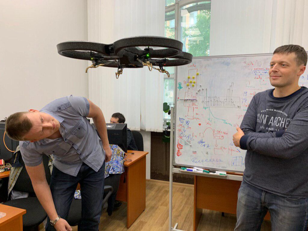 drone hovering in front of a whiteboard