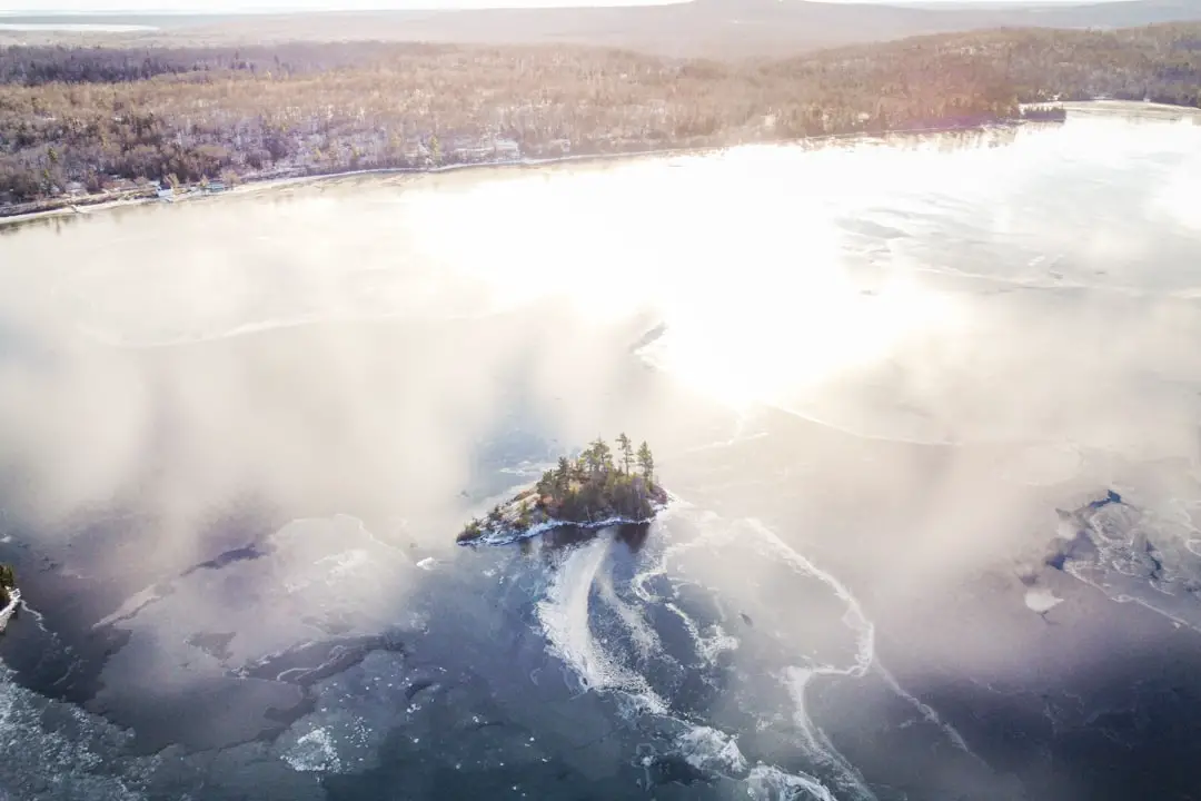 an aerial view of a small island in the middle of a lake