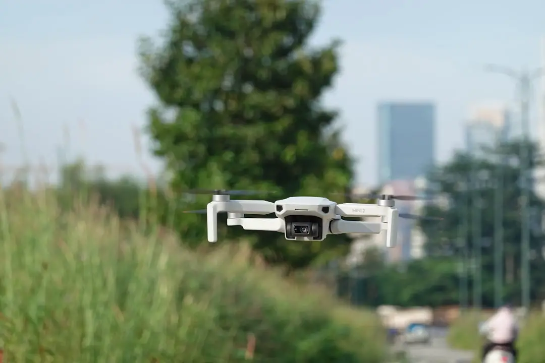 a white remote controlled flying over a street